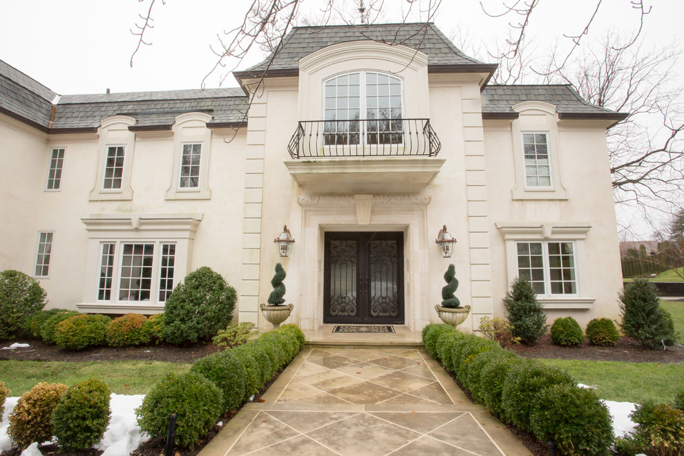 Design ideas for a large traditional two-storey stucco white exterior in Philadelphia.