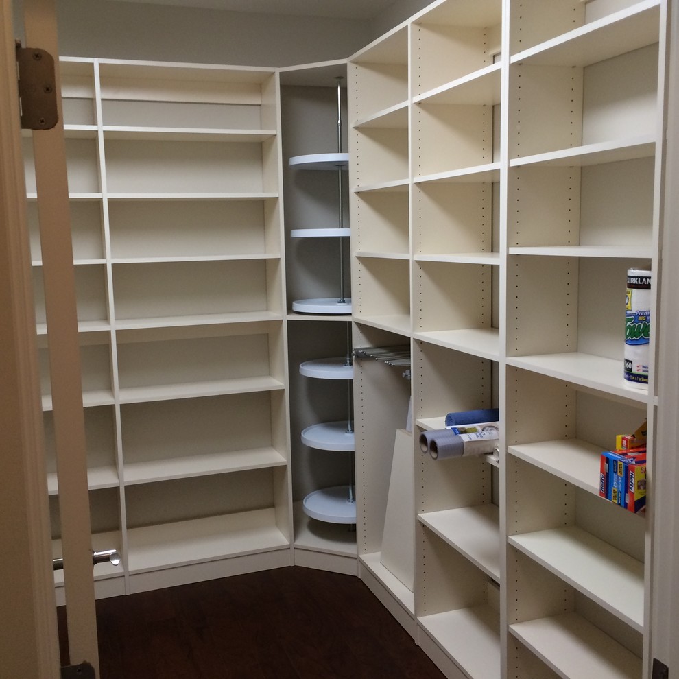 Photo of a large traditional walk-in wardrobe in Other with white cabinets, medium hardwood floors and brown floor.
