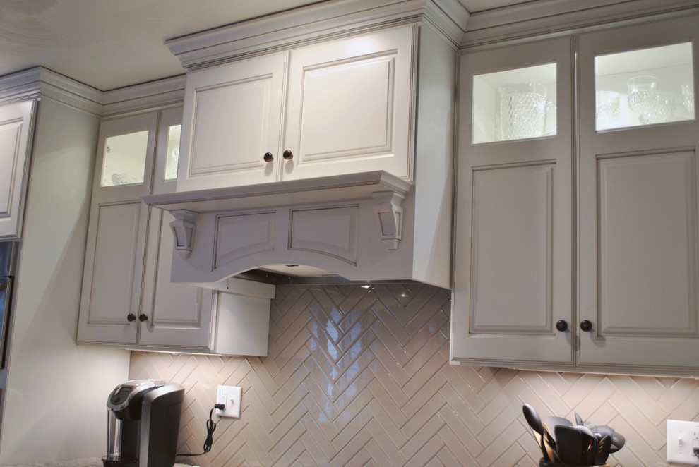 Inspiration for a transitional l-shaped open plan kitchen in St Louis with raised-panel cabinets, white cabinets, granite benchtops, white splashback, ceramic splashback, stainless steel appliances, medium hardwood floors and with island.
