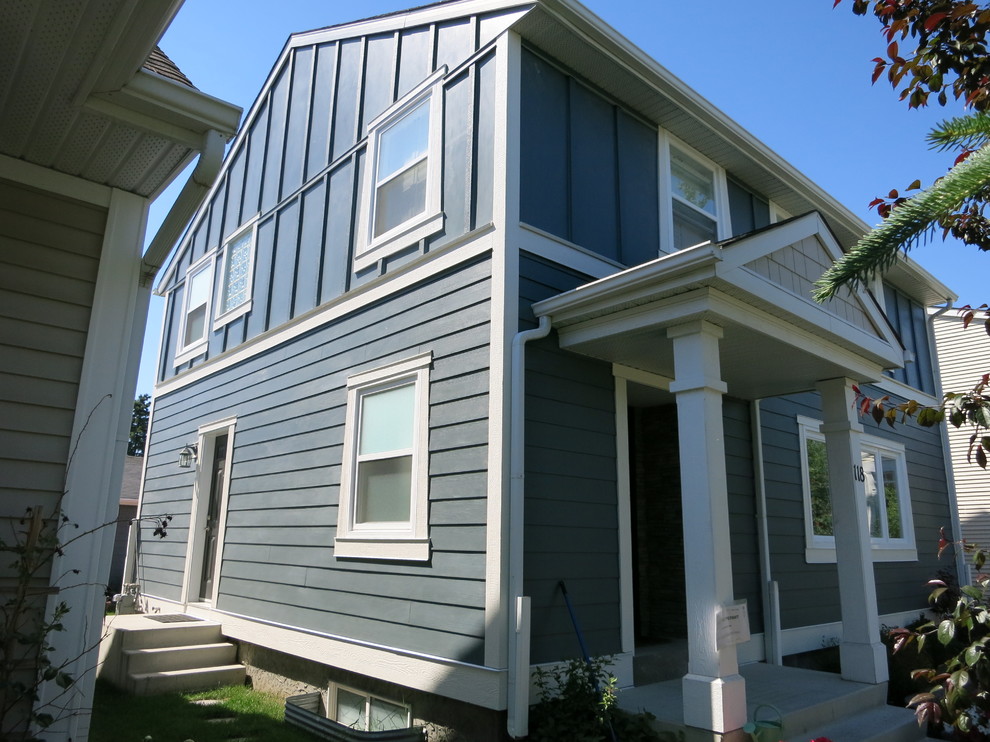 Mid-sized traditional two-storey grey house exterior in Calgary with concrete fiberboard siding, a gable roof and a shingle roof.