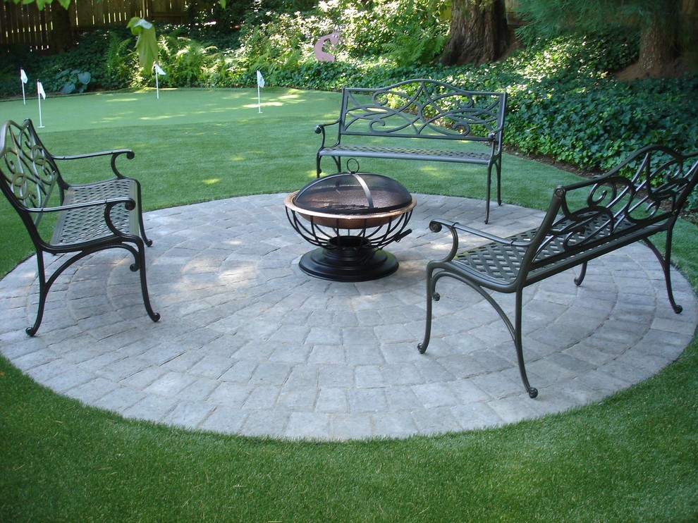 Inspiration for a mid-sized transitional backyard patio in Portland with a fire feature, concrete pavers and no cover.