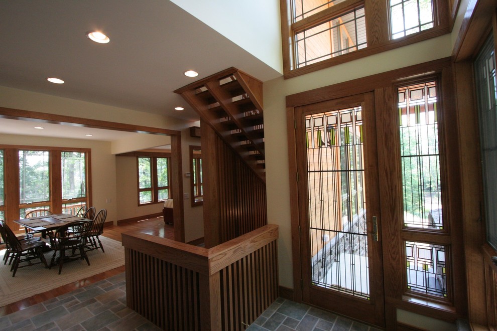 Inspiration for a mid-sized arts and crafts foyer in Cincinnati with multi-coloured walls, slate floors, a single front door and a medium wood front door.