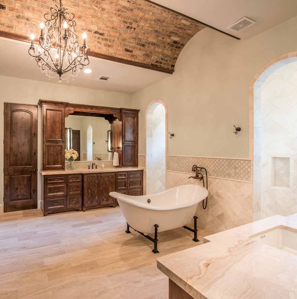 Photo of a large mediterranean master bathroom in Houston with raised-panel cabinets, dark wood cabinets, a freestanding tub, beige tile, ceramic tile, green walls, ceramic floors, an undermount sink, marble benchtops, beige floor, a double shower and an open shower.