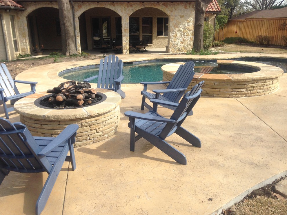 Inspiration for a large rustic backyard stamped concrete and custom-shaped natural hot tub remodel in Dallas