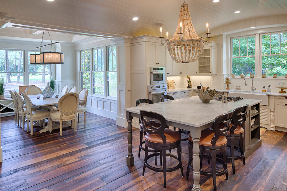 Design ideas for a mid-sized country l-shaped eat-in kitchen in Grand Rapids with a double-bowl sink, recessed-panel cabinets, white cabinets, marble benchtops, stainless steel appliances, dark hardwood floors and with island.
