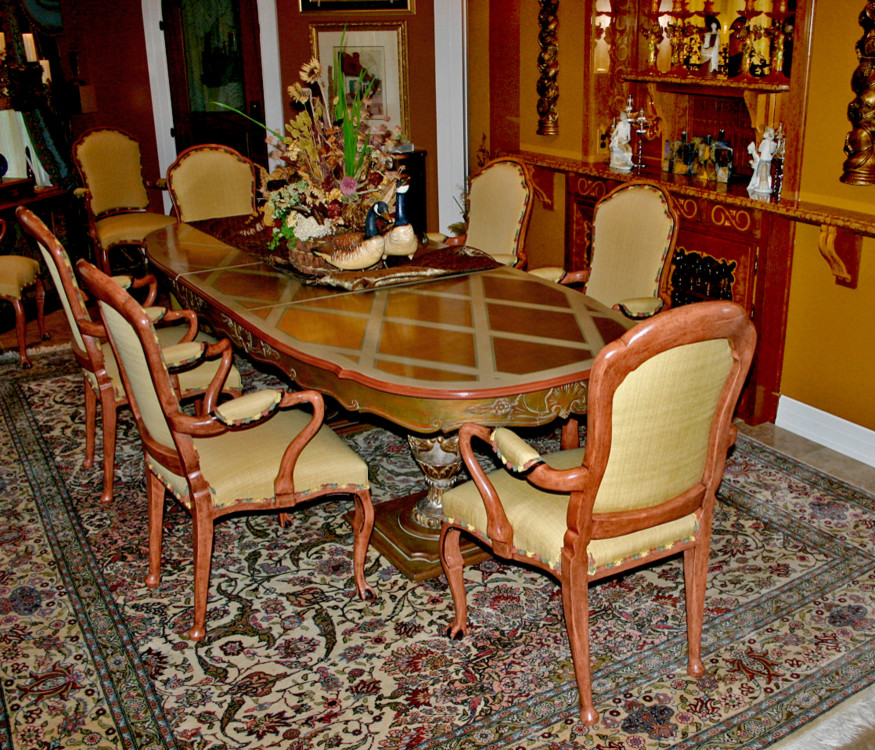 Mid-sized mediterranean separate dining room in Tampa with brown walls and travertine floors.