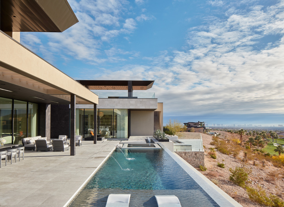 This is an example of a large classic back rectangular infinity swimming pool in Salt Lake City with a water feature.