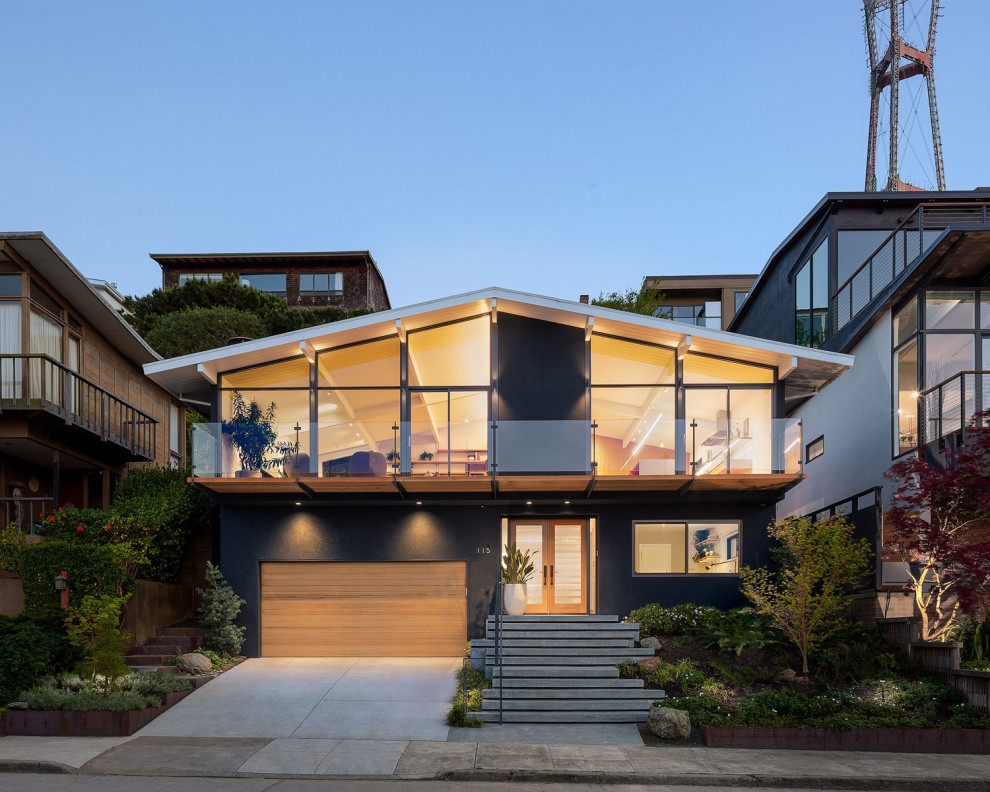 This is an example of a mid-sized midcentury two-storey blue house exterior in San Francisco with a grey roof.