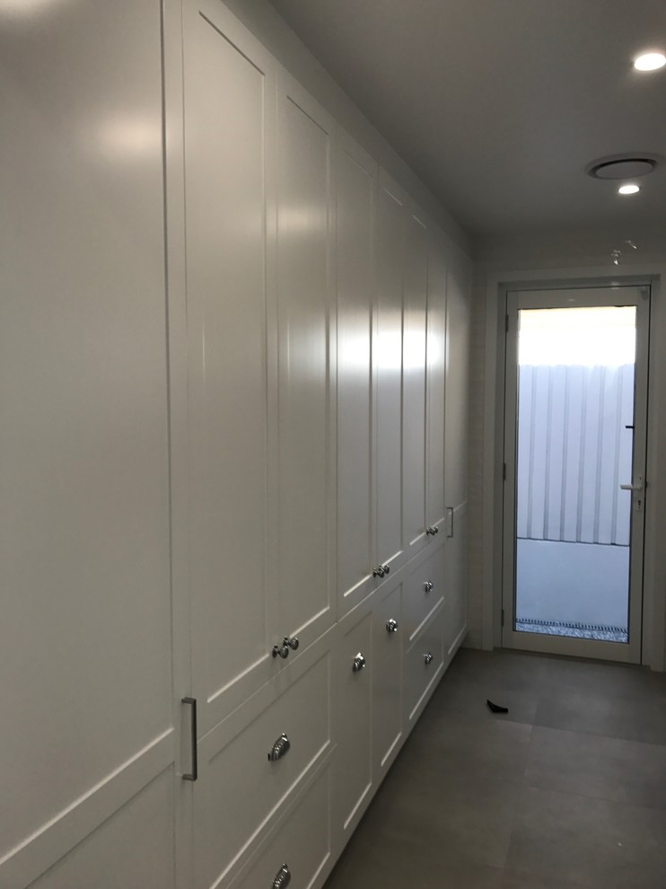 Design ideas for a large traditional single-wall dedicated laundry room in Brisbane with shaker cabinets, white cabinets, white walls, porcelain floors and grey floor.