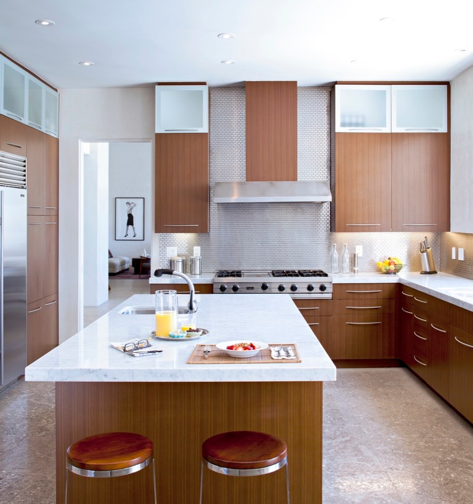 This is an example of a contemporary l-shaped kitchen in Los Angeles with medium wood cabinets, marble benchtops, metallic splashback, stainless steel appliances, with island, a single-bowl sink, flat-panel cabinets and metal splashback.