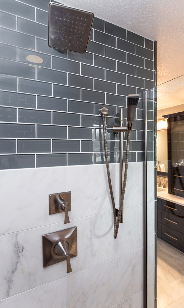 Home design - mid-sized transitional master gray tile and mosaic tile marble floor home design idea with an undermount sink, recessed-panel cabinets, dark wood cabinets, quartzite countertops, a one-piece toilet and gray walls
