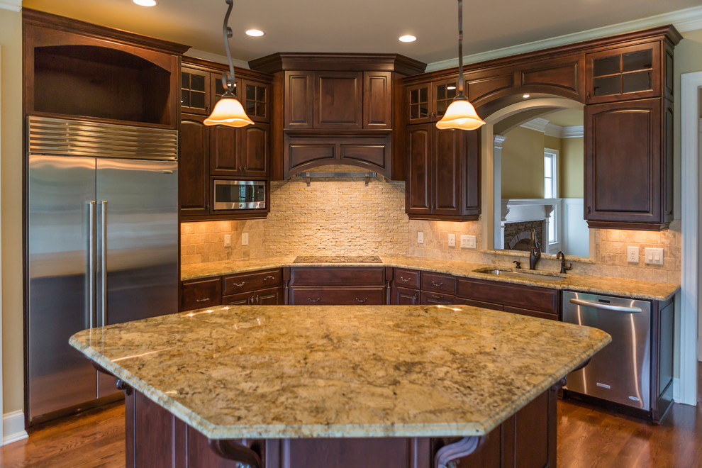 This is an example of a mid-sized single-wall kitchen in Raleigh with flat-panel cabinets, beige cabinets, granite benchtops, beige splashback, stone tile splashback and stainless steel appliances.