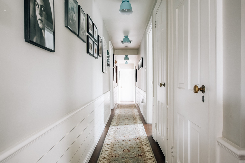 This is an example of a country hallway in San Francisco with grey walls, dark hardwood floors and brown floor.