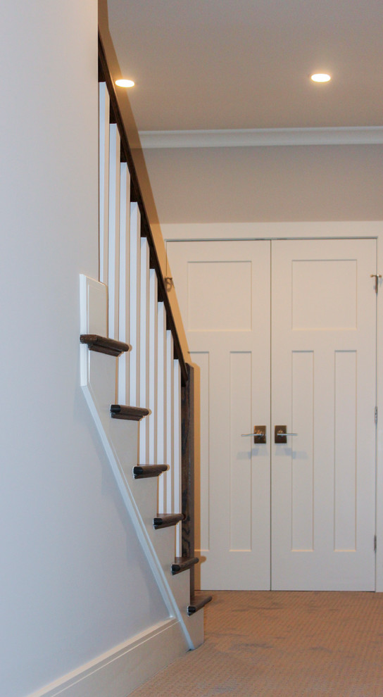 This is an example of a large transitional wood straight staircase in DC Metro with wood risers and wood railing.