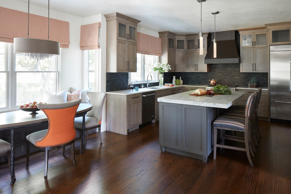 Transitional l-shaped dark wood floor and brown floor eat-in kitchen photo in New York with an undermount sink, shaker cabinets, medium tone wood cabinets, black backsplash, stone tile backsplash, stainless steel appliances, an island and white countertops