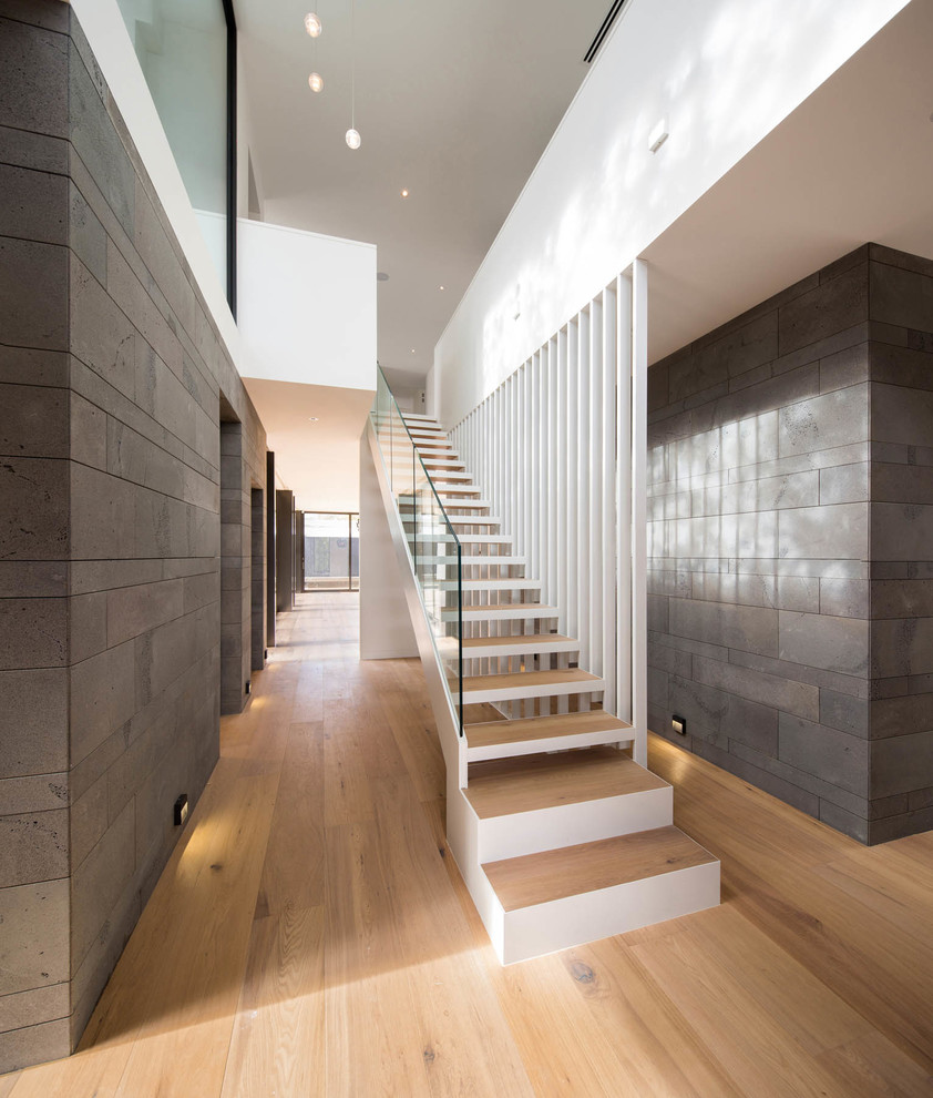 Inspiration for a mid-sized contemporary wood straight staircase in Melbourne with open risers.