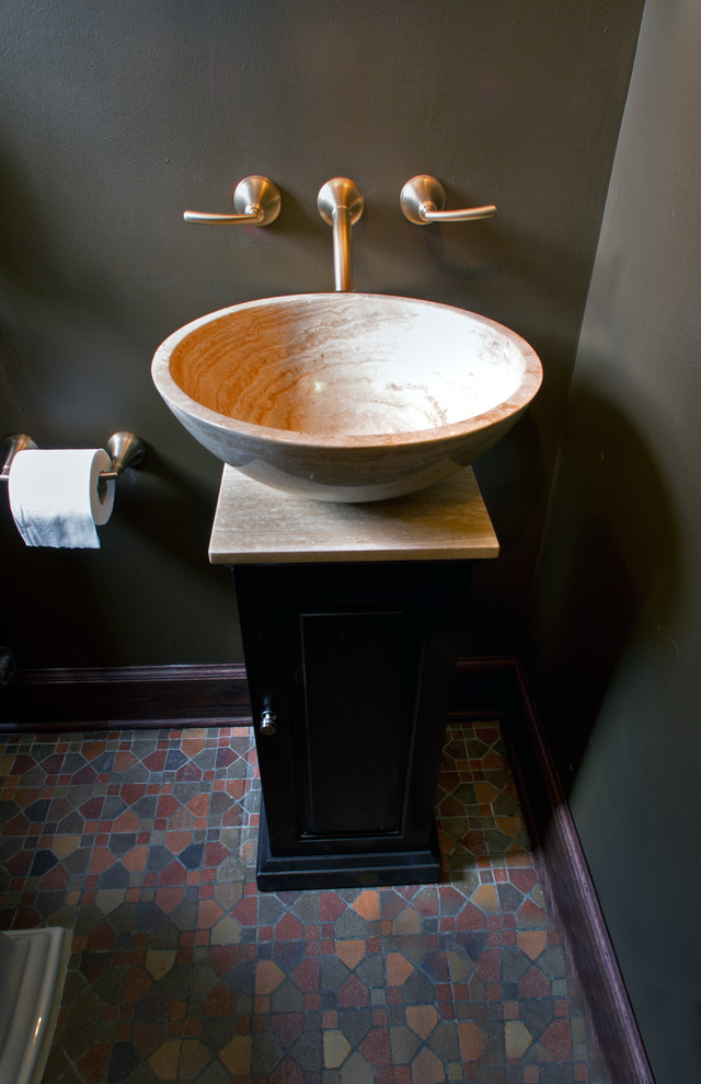 Powder room - small traditional terrazzo floor powder room idea in Milwaukee with a vessel sink, dark wood cabinets, marble countertops, a two-piece toilet and brown walls