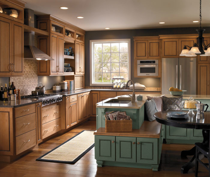 Inspiration for a mid-sized traditional l-shaped eat-in kitchen in Philadelphia with an undermount sink, beaded inset cabinets, medium wood cabinets, stainless steel benchtops, brown splashback, ceramic splashback, stainless steel appliances, medium hardwood floors, with island and brown floor.