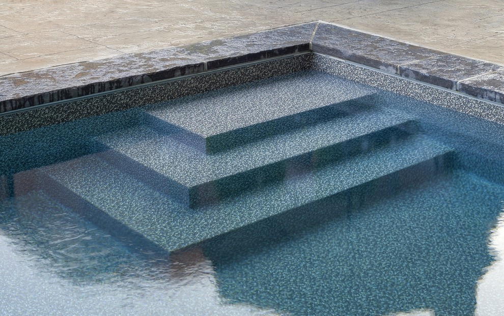 Photo of a small contemporary backyard rectangular pool in Toronto with stamped concrete.