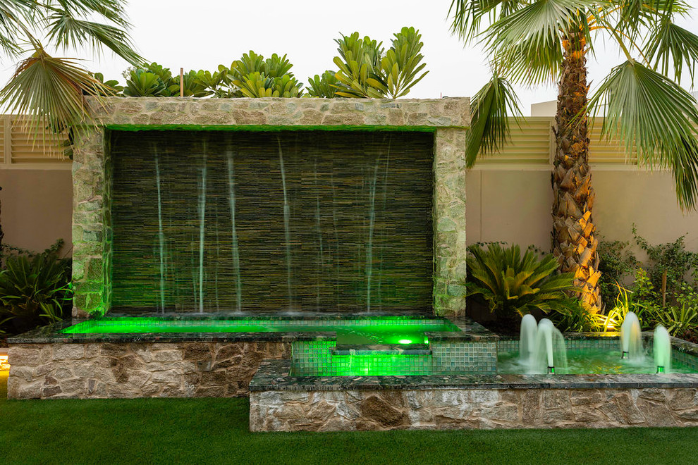 Contemporary patio in Other with a water feature.