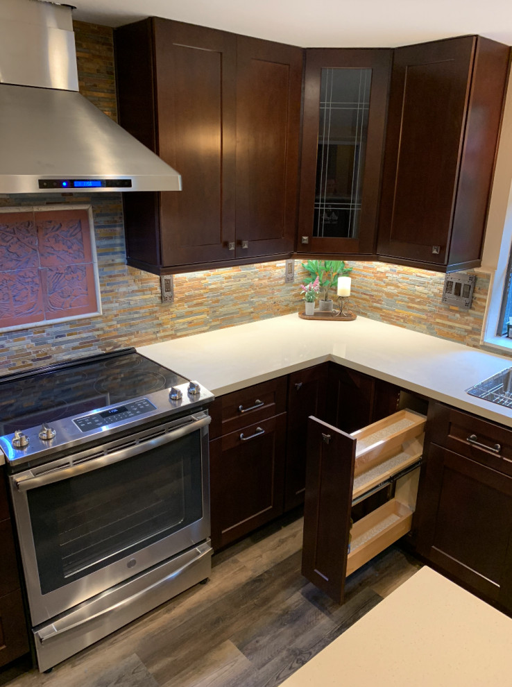 Photo of a mid-sized traditional u-shaped separate kitchen in San Francisco with an undermount sink, louvered cabinets, dark wood cabinets, quartzite benchtops, multi-coloured splashback, stone tile splashback, stainless steel appliances, medium hardwood floors, with island, beige floor and beige benchtop.