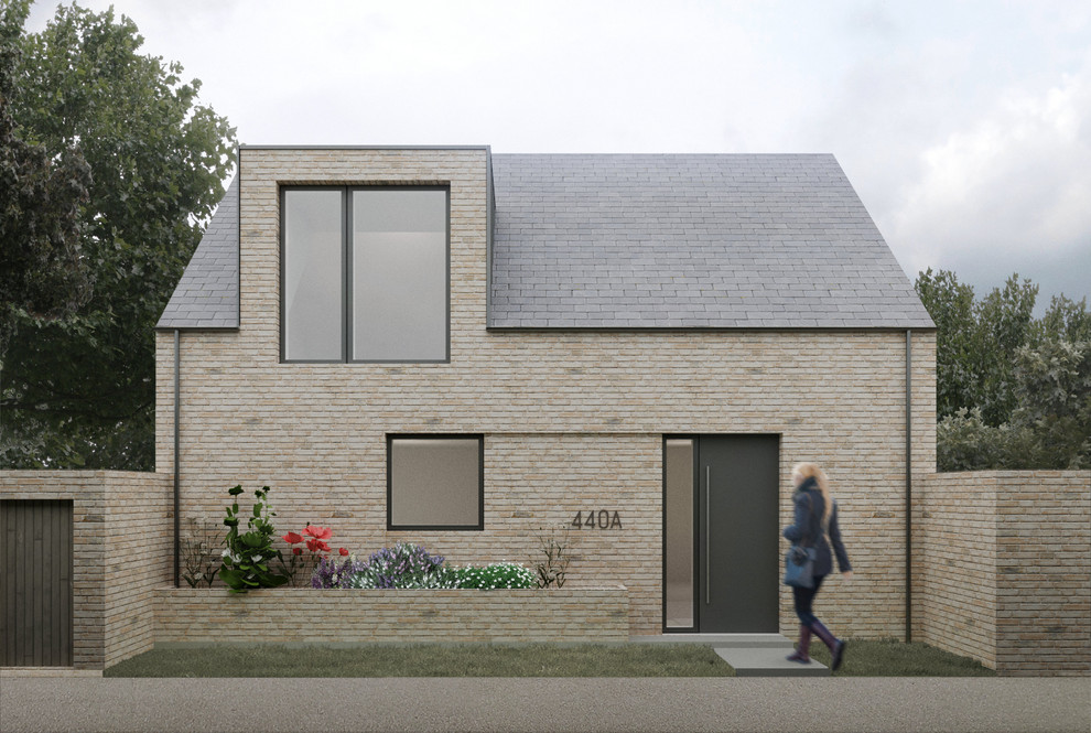 Design ideas for a small contemporary two-storey brick beige house exterior in Cambridgeshire with a gable roof and a metal roof.