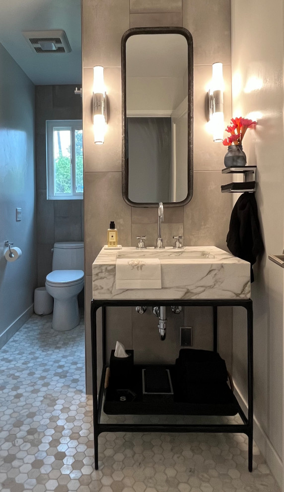 This is an example of a small transitional 3/4 bathroom in San Diego with open cabinets, black cabinets, an alcove shower, a one-piece toilet, gray tile, porcelain tile, white walls, marble floors, an undermount sink, marble benchtops, multi-coloured floor, white benchtops, a single vanity and a freestanding vanity.