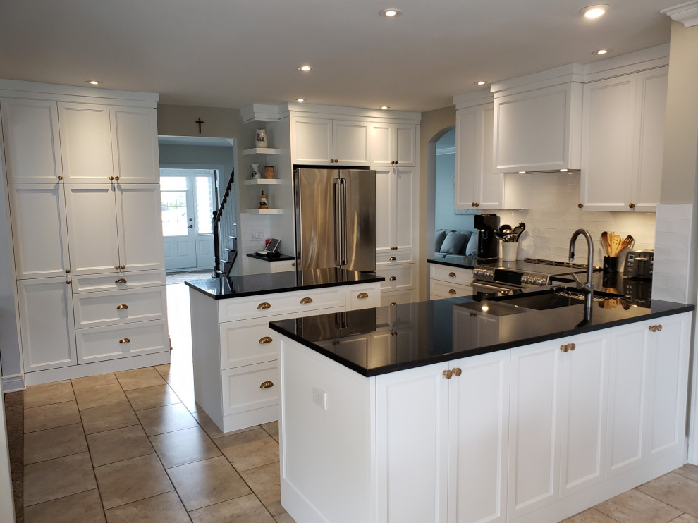 Inspiration for a transitional u-shaped open concept kitchen remodel in Montreal with two islands