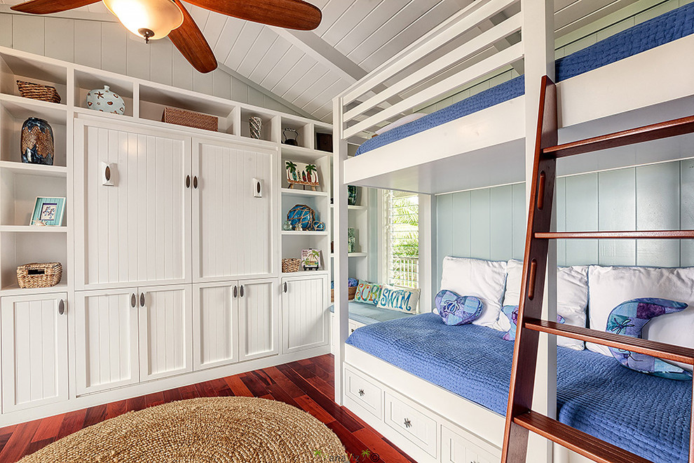 Photo of a tropical gender-neutral kids' bedroom for kids 4-10 years old in Hawaii with white walls and dark hardwood floors.