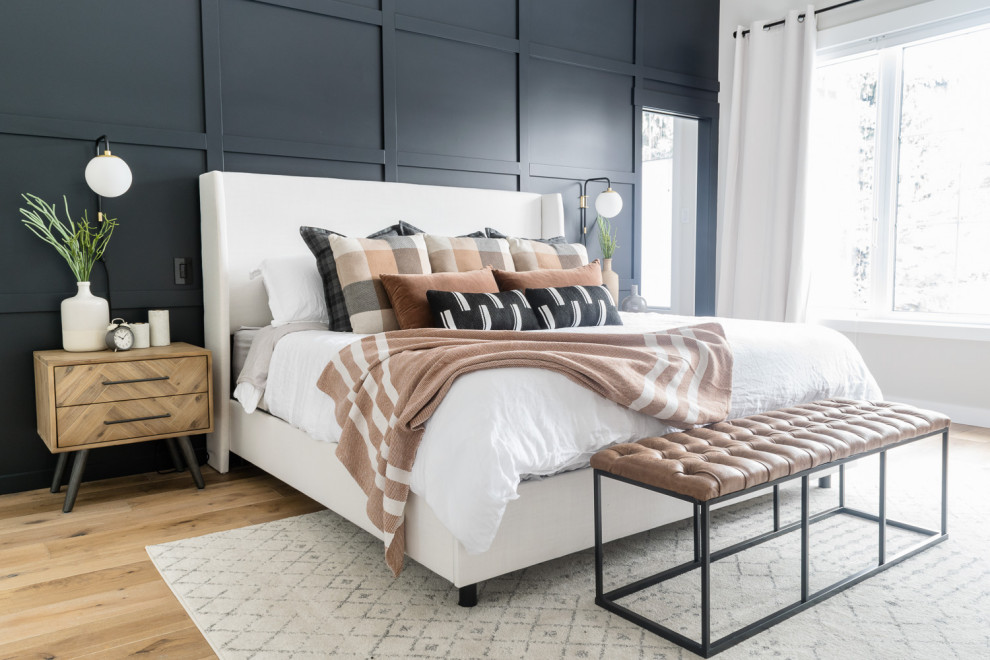 Large transitional master bedroom in Other with black walls, medium hardwood floors, no fireplace and brown floor.