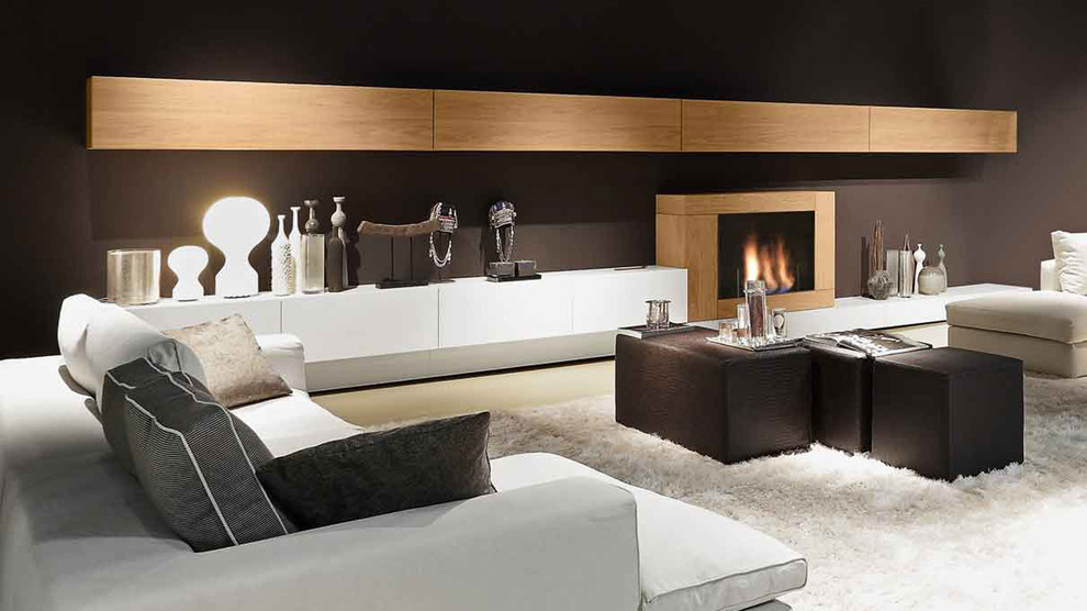 Large modern formal open concept living room in Boston with brown walls, a standard fireplace, a wood fireplace surround, no tv and beige floor.