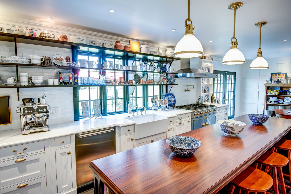 Inspiration for a large eclectic u-shaped eat-in kitchen in Philadelphia with beaded inset cabinets, white cabinets, wood benchtops, white splashback and black floor.