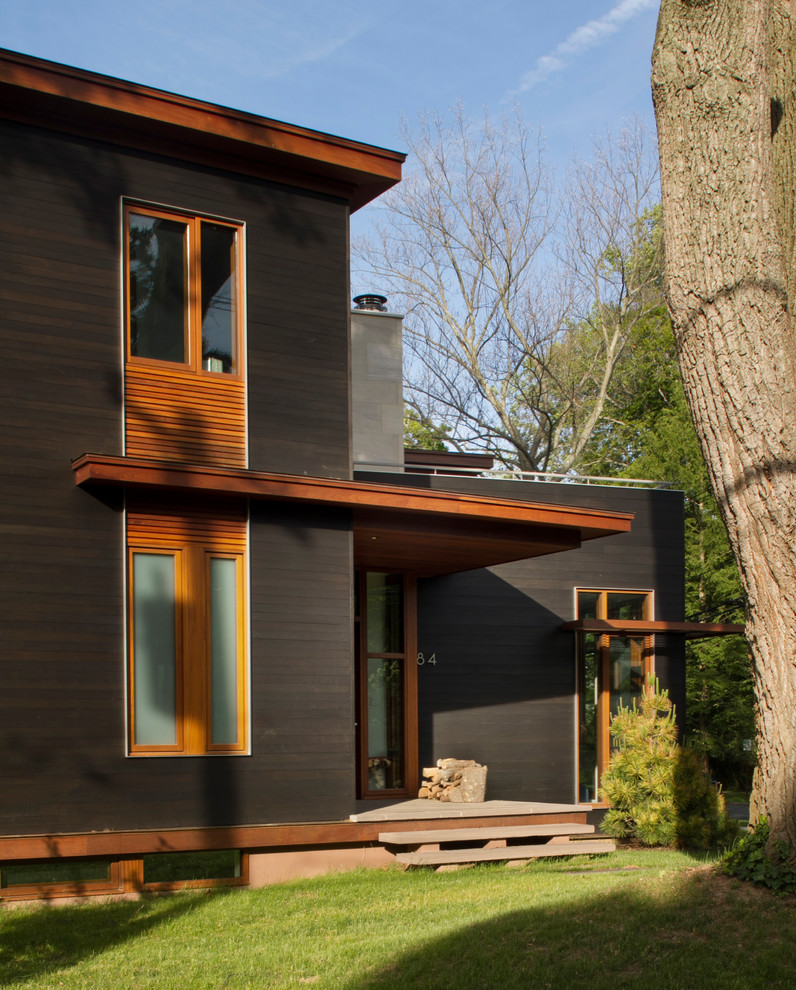 Design ideas for a large modern two-storey grey exterior in New York with mixed siding and a flat roof.