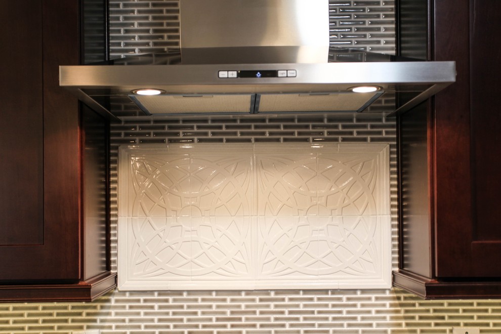 Large transitional u-shaped porcelain tile eat-in kitchen photo in Chicago with an undermount sink, recessed-panel cabinets, dark wood cabinets, granite countertops, gray backsplash, glass tile backsplash, stainless steel appliances and an island