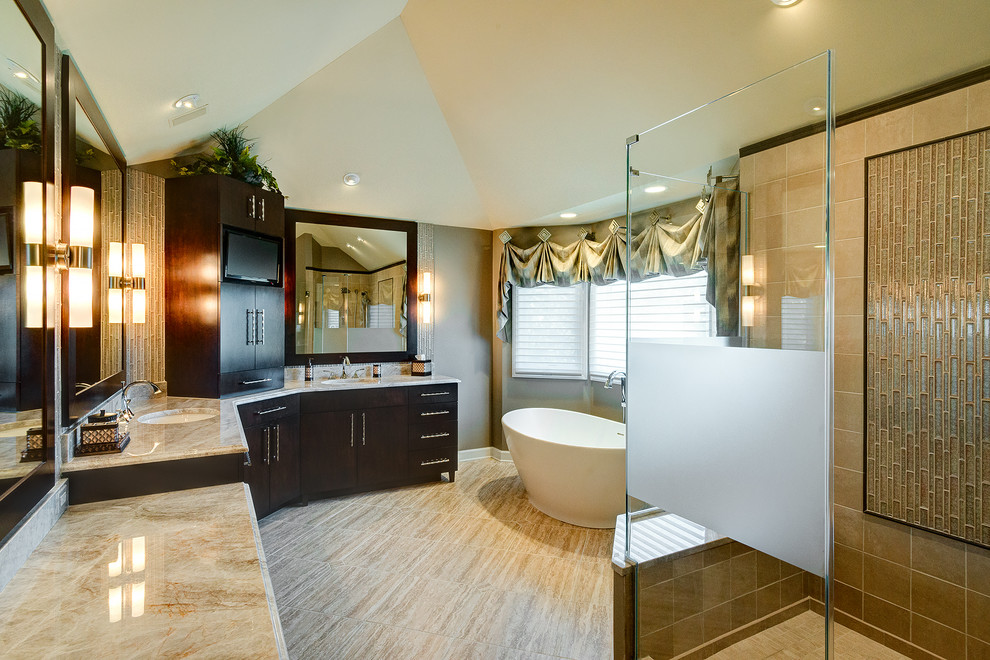 Large contemporary master bathroom in Chicago with flat-panel cabinets, dark wood cabinets, a freestanding tub, a corner shower, beige tile, beige walls, marble floors, an undermount sink and granite benchtops.