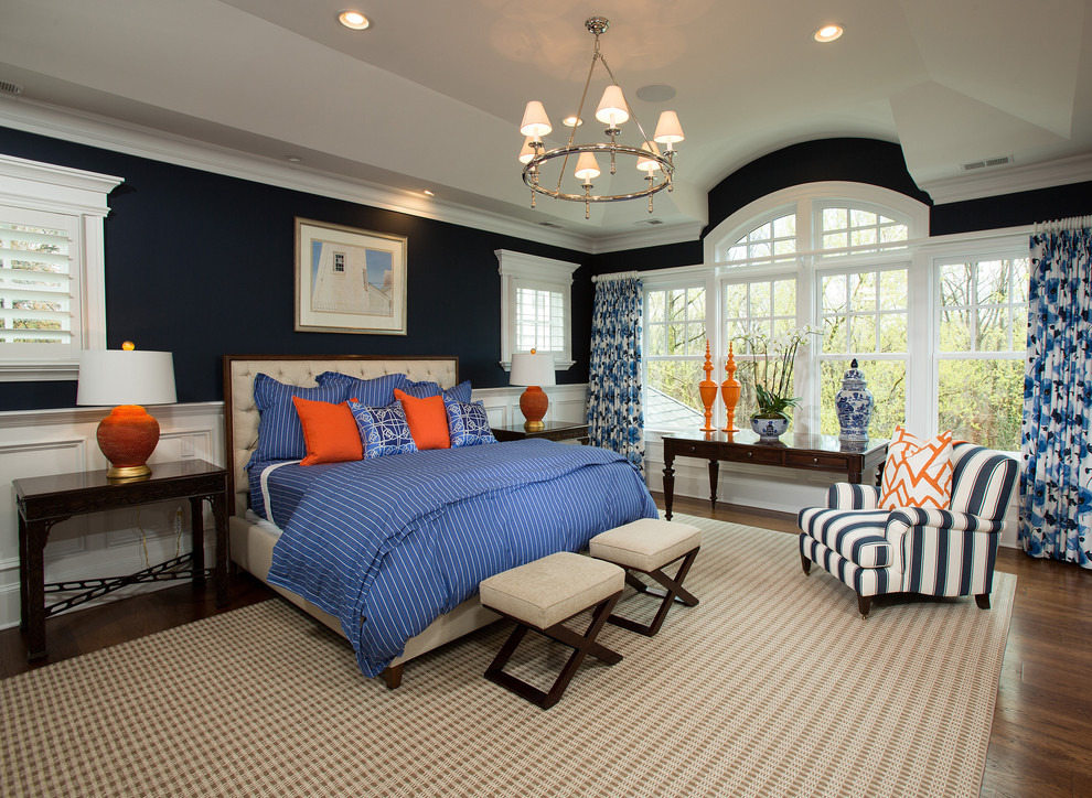 Design ideas for a large beach style master bedroom in DC Metro with blue walls and medium hardwood floors.