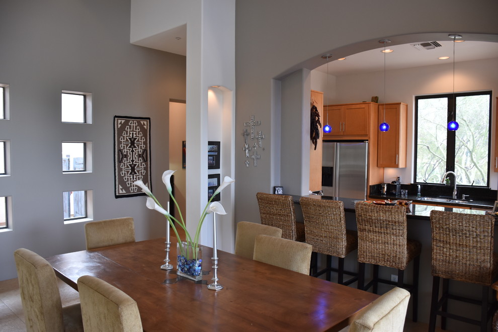 Example of a mid-sized transitional travertine floor and beige floor great room design in Phoenix with gray walls and no fireplace