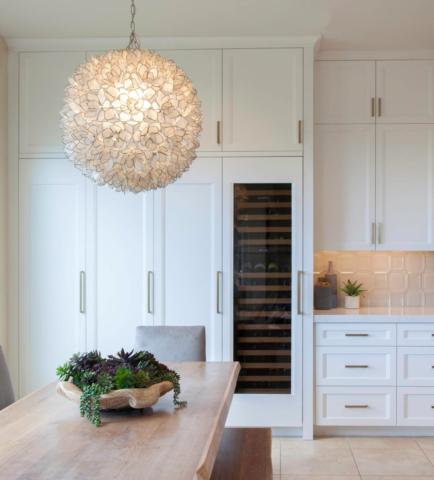 Large transitional l-shaped open concept kitchen photo in Denver with shaker cabinets, white cabinets and an island