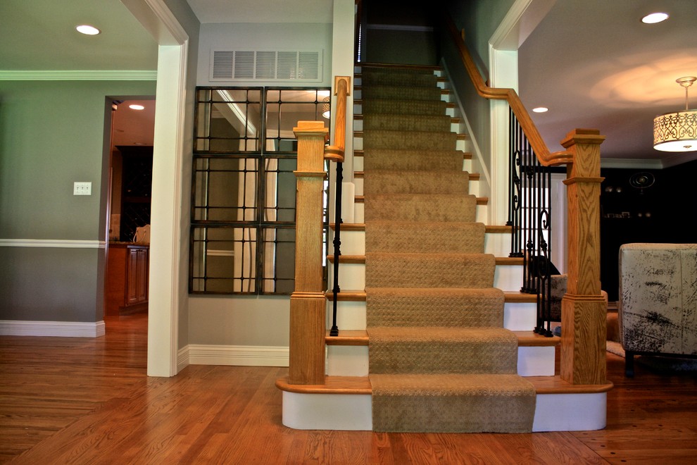 This is an example of a transitional wood straight staircase in St Louis with painted wood risers.