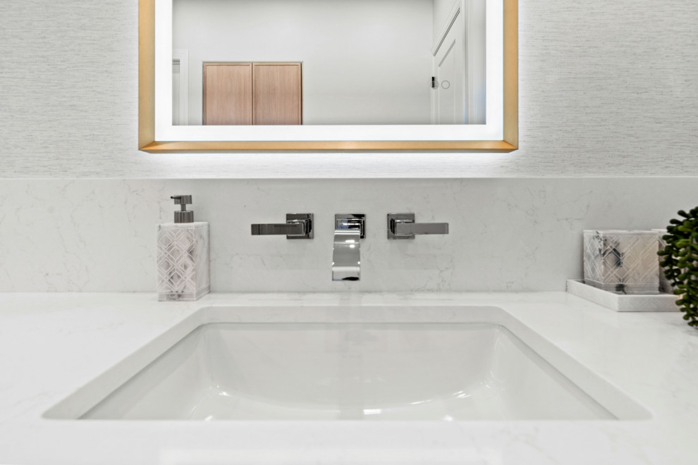 Inspiration for a transitional master gray tile and porcelain tile porcelain tile, white floor and double-sink walk-in shower remodel with shaker cabinets, light wood cabinets, a two-piece toilet, white walls, an undermount sink, quartz countertops, white countertops, a niche and a built-in vanity