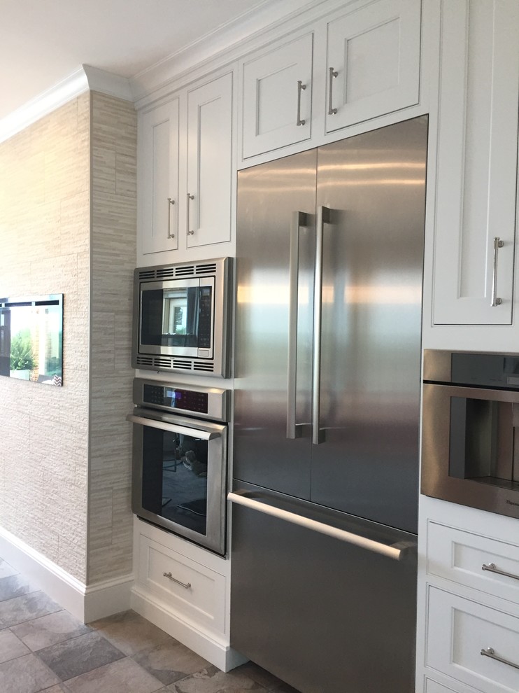 Inspiration for a large transitional ceramic tile and multicolored floor kitchen remodel with a farmhouse sink, beaded inset cabinets, white cabinets, quartz countertops, metallic backsplash, ceramic backsplash, stainless steel appliances and an island