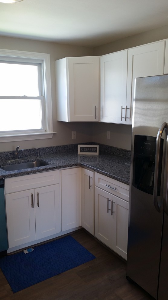Eat-in kitchen - mid-sized transitional l-shaped eat-in kitchen idea in Providence with a single-bowl sink, shaker cabinets, white cabinets, granite countertops, stainless steel appliances and a peninsula