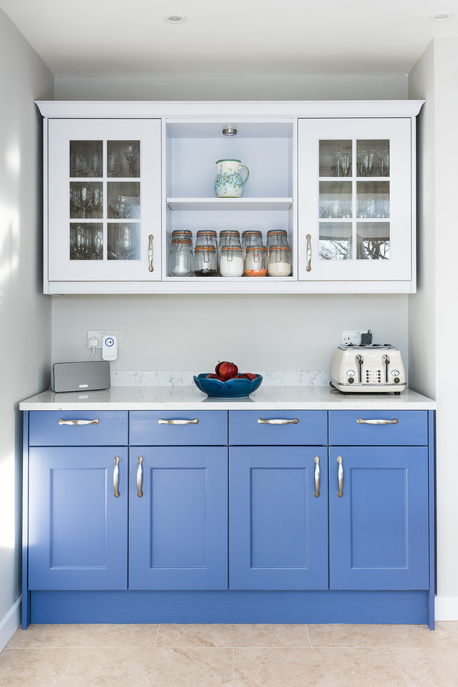 Inspiration for a large transitional single-wall open plan kitchen in Buckinghamshire with a double-bowl sink, shaker cabinets, blue cabinets, quartzite benchtops, white splashback, subway tile splashback, black appliances, porcelain floors, with island, beige floor and yellow benchtop.