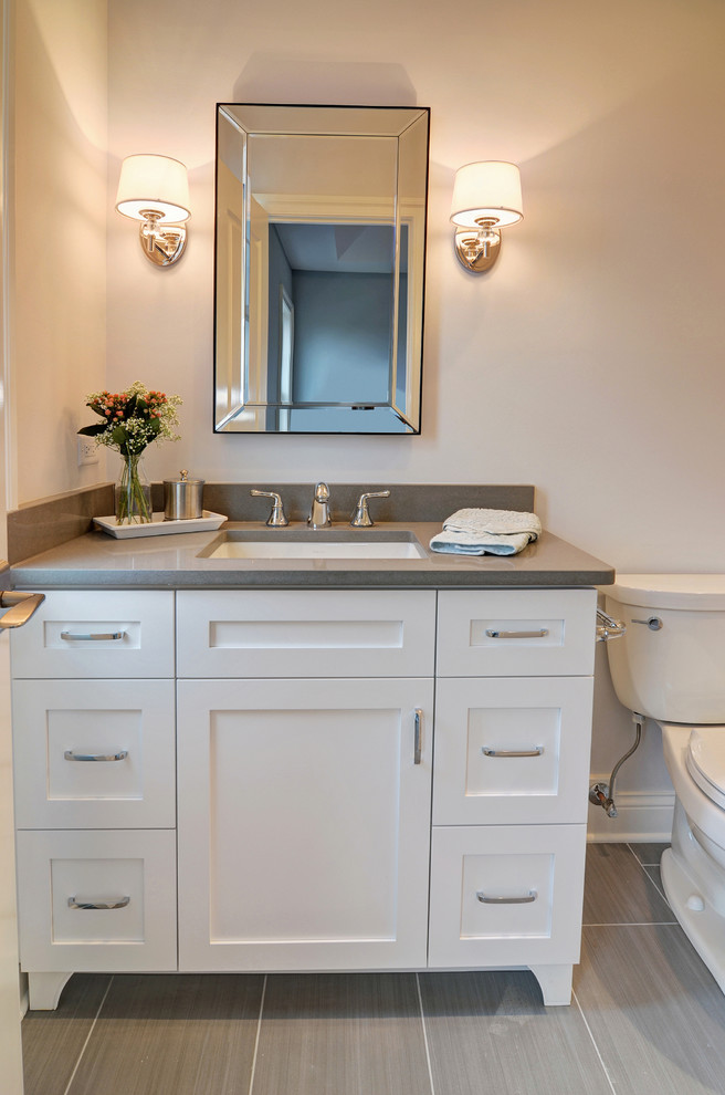 Example of a mid-sized transitional kids' gray tile and porcelain tile porcelain tile bathroom design in Chicago with recessed-panel cabinets, white cabinets, gray walls, an undermount sink and quartz countertops
