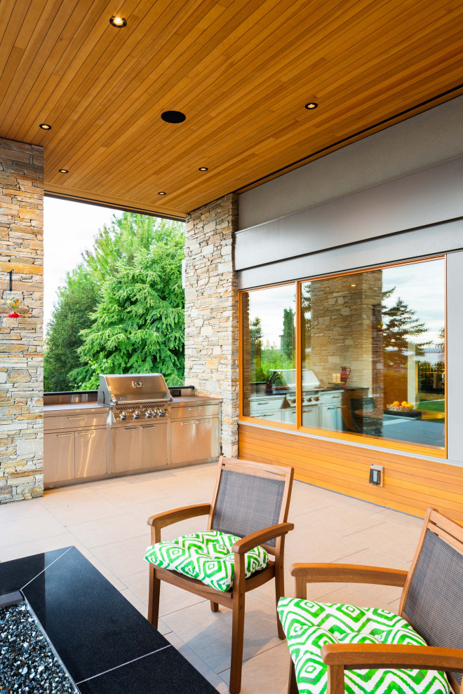 Mid-sized contemporary two-storey brown house exterior in Vancouver with stone veneer and a flat roof.
