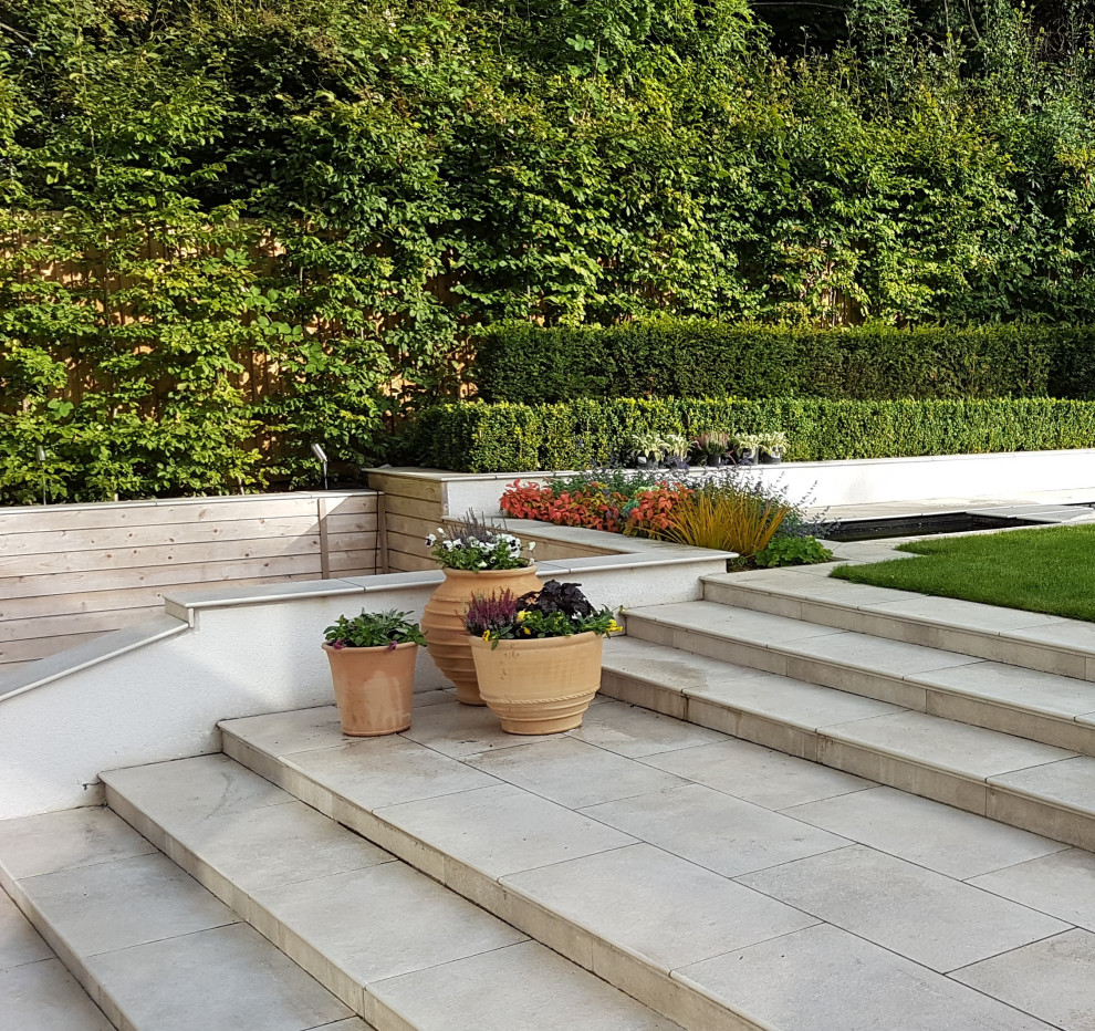 This is an example of a large contemporary back formal partial sun garden in West Midlands.