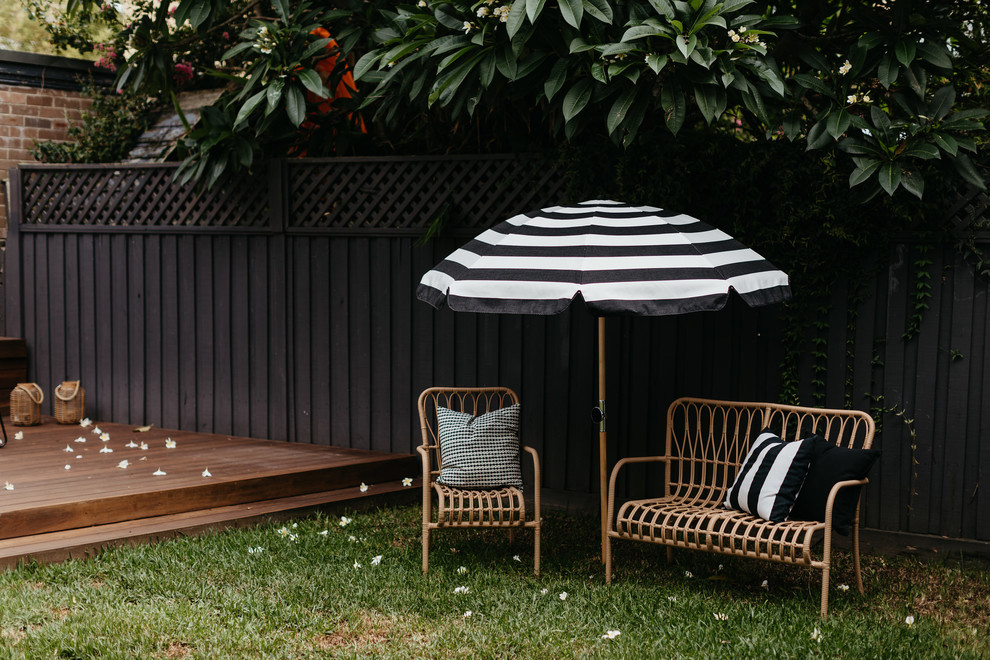 This is an example of a small beach style side yard deck in Sydney with no cover.
