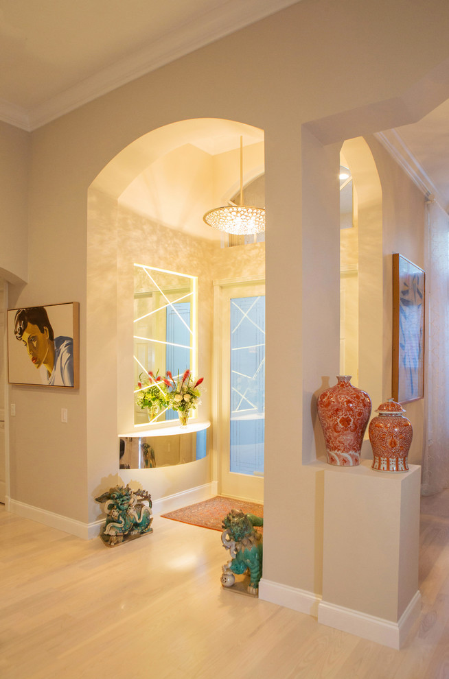 Photo of a mid-sized contemporary foyer in Miami with beige walls, light hardwood floors, a single front door, a glass front door and beige floor.