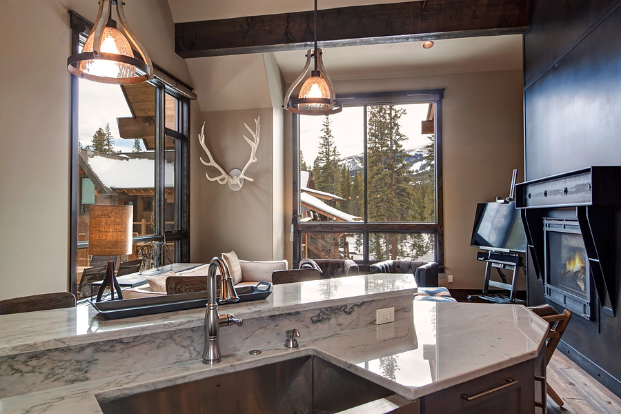 Transitional u-shaped medium tone wood floor eat-in kitchen photo in Denver with a farmhouse sink, recessed-panel cabinets, gray cabinets, marble countertops, white backsplash, ceramic backsplash, stainless steel appliances and an island
