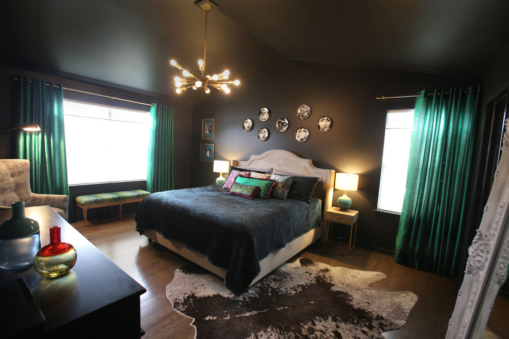 Photo of a mid-sized eclectic master bedroom in Detroit with black walls, dark hardwood floors and brown floor.